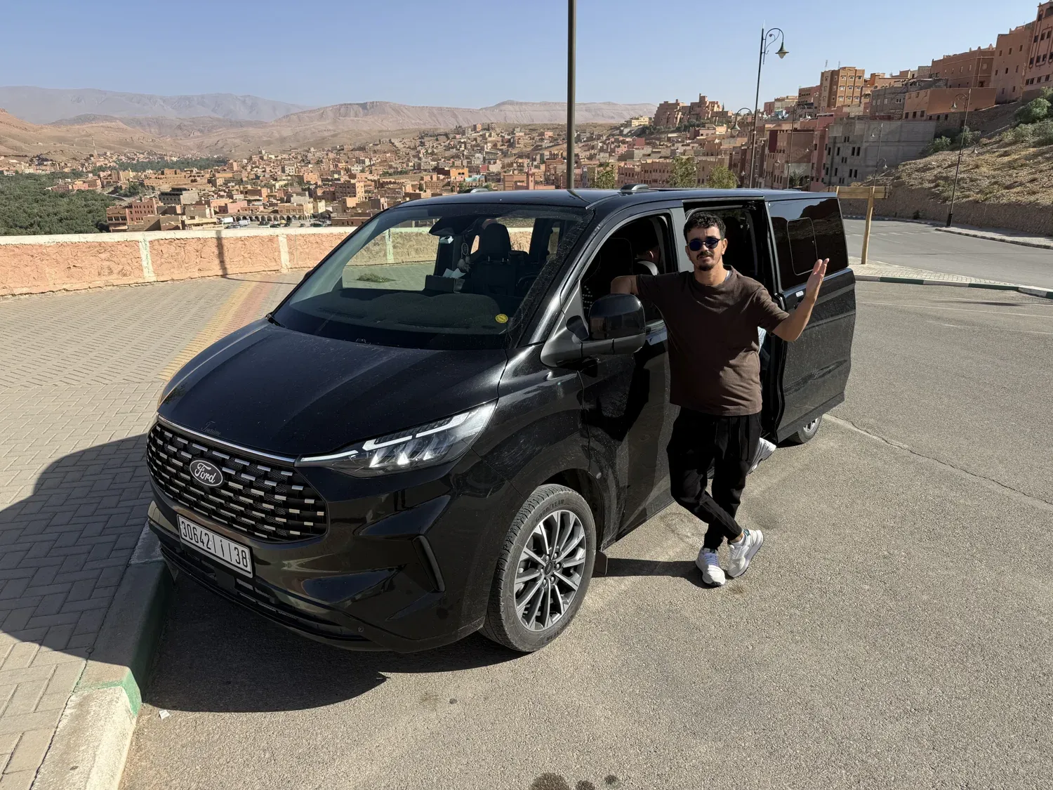 Mohamed waves next to the van